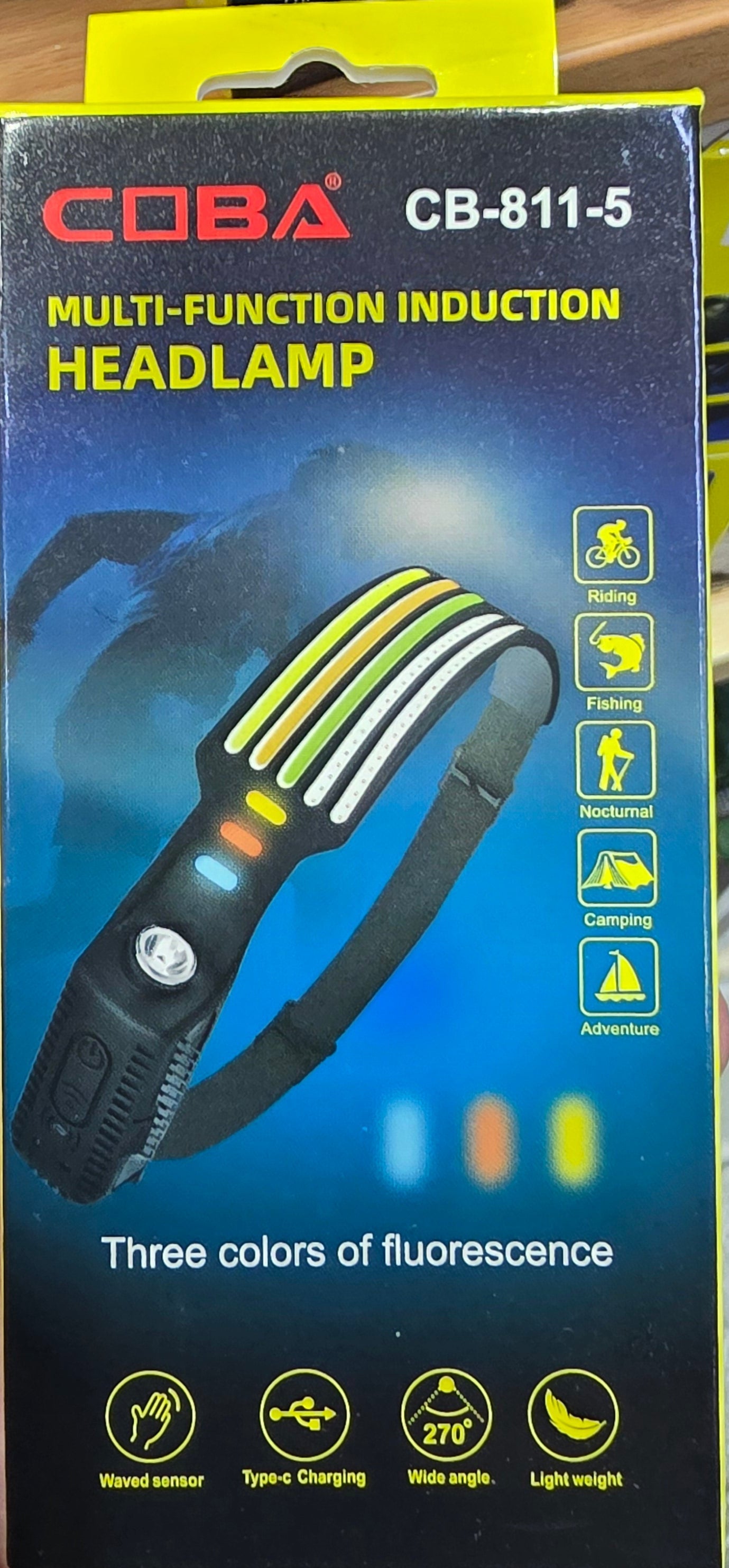 Coba multi-function headlamp packaging held in a hand with a store shelf in the background